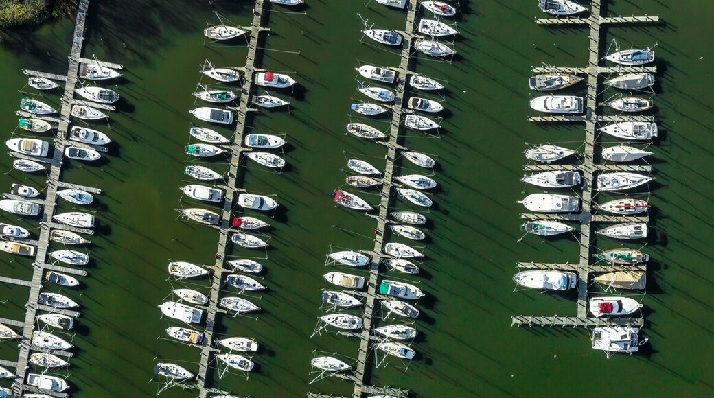 Aerial panorama of Deale waterfront docks on the Western Shore of Chesapeake Bay Maryland, with rows of of luxury sailboats docking in the marina.