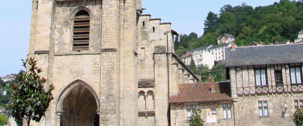 A historic church with a tall spire and arched windows.