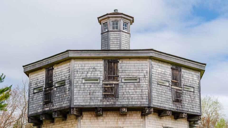 A historic building with a tower and multiple windows.