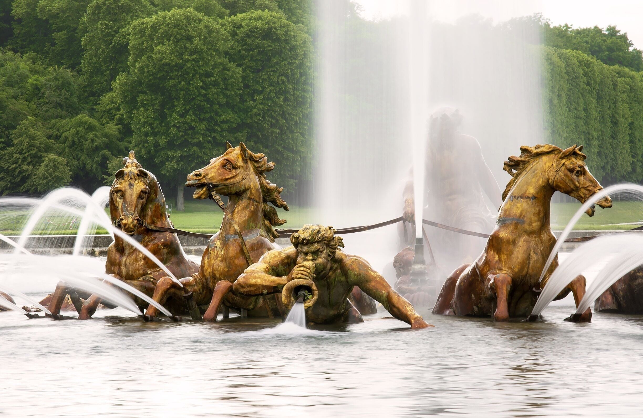 A Triton calms the sea while announcing the return of Apollo.  The Apollo Fountain shows the Greek god rising from the sea for his daily flight. He rides a gilded lead chariot pulled forth by four horses. This fountain was installed in the 17th century.