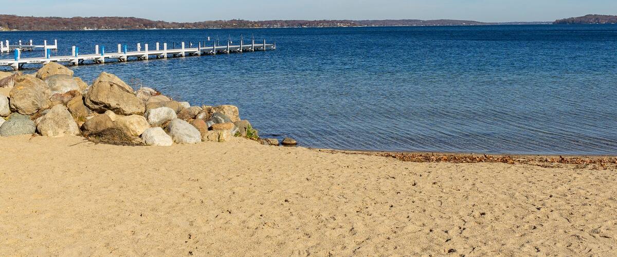 A beach on a northern lake on a clear day.