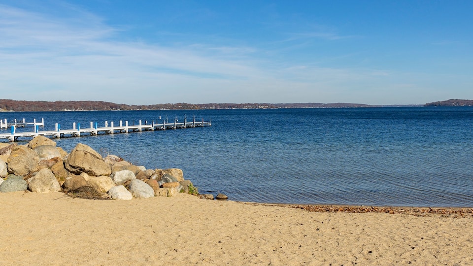 A beach on a northern lake on a clear day.