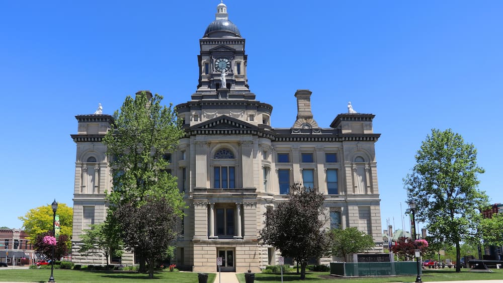 A large, historic building with a clock tower and columns.