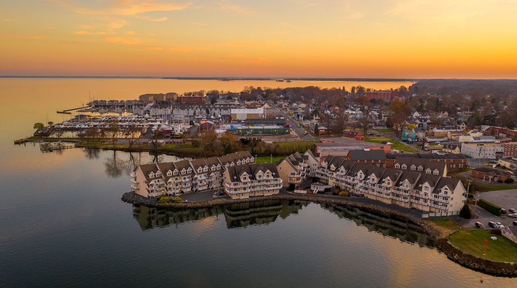 Aerial view of downtown Havre de Grace in Maryland with luxury waterfront apartment complex reflecting in the water as the sun paints the sky orange