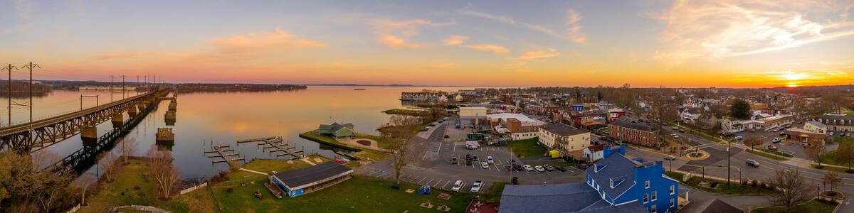 Aerial sunset panorama of Havre de Grace Maryland with orange sky and clouds reflecting on the Susquehanna River and the Chesapeake Bay one of the best small towns in America