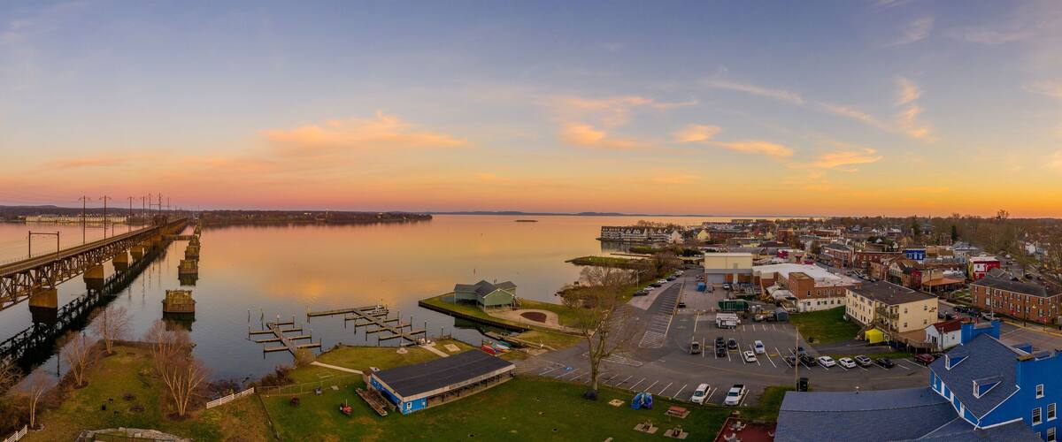Aerial sunset panorama of Havre de Grace Maryland with orange sky and clouds reflecting on the Susquehanna River and the Chesapeake Bay one of the best small towns in America