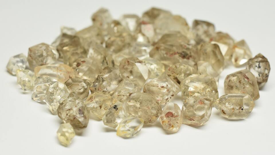 A collection of clear, faceted gemstones.