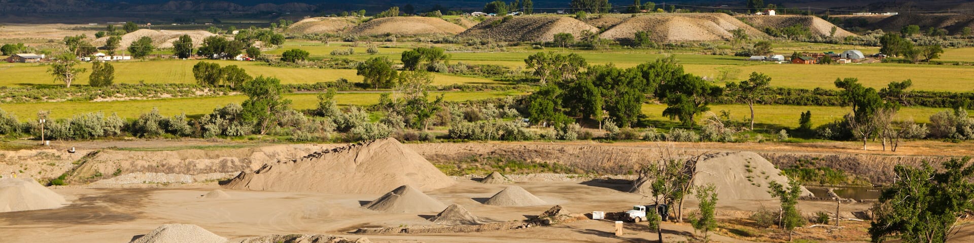 Croplands, gravel piles, and terraces in the North Fork Valley near Hotchkiss, Colorado.
