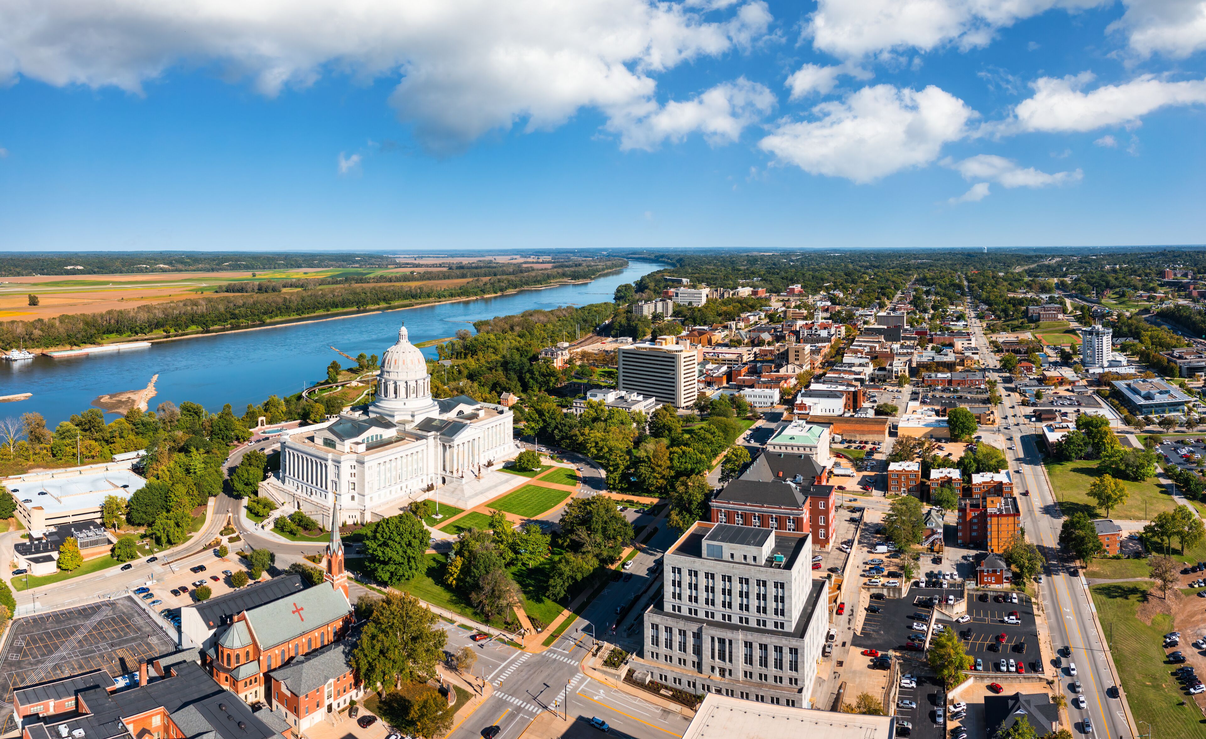 A river, a large white building, and a cityscape.