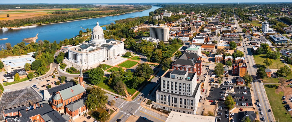 A river, a large white building, and a cityscape.