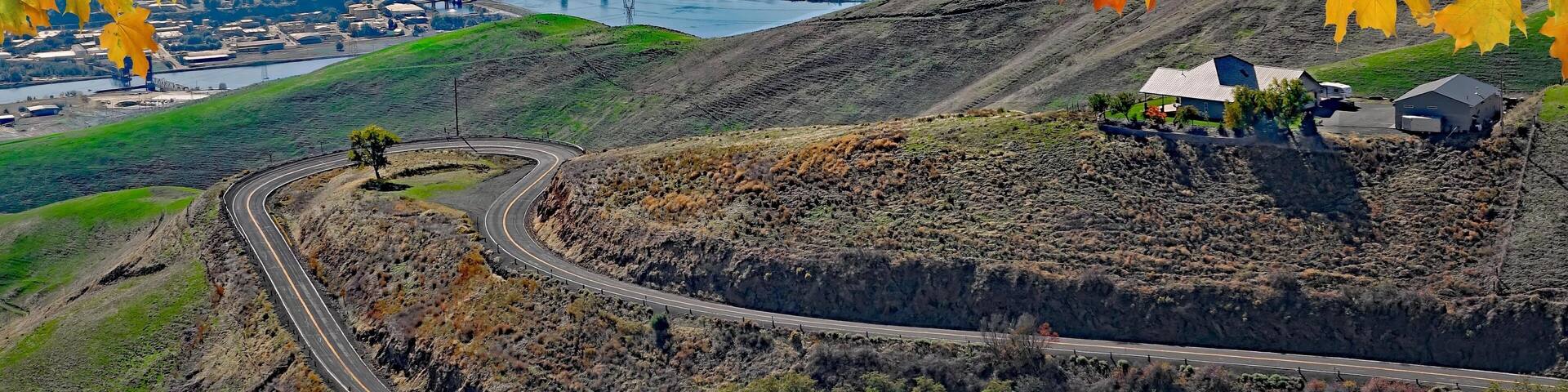 View of Lewiston, Idaho and Clarkston, Wa from the Lewiston Hill overlook framed by fall maple leaves