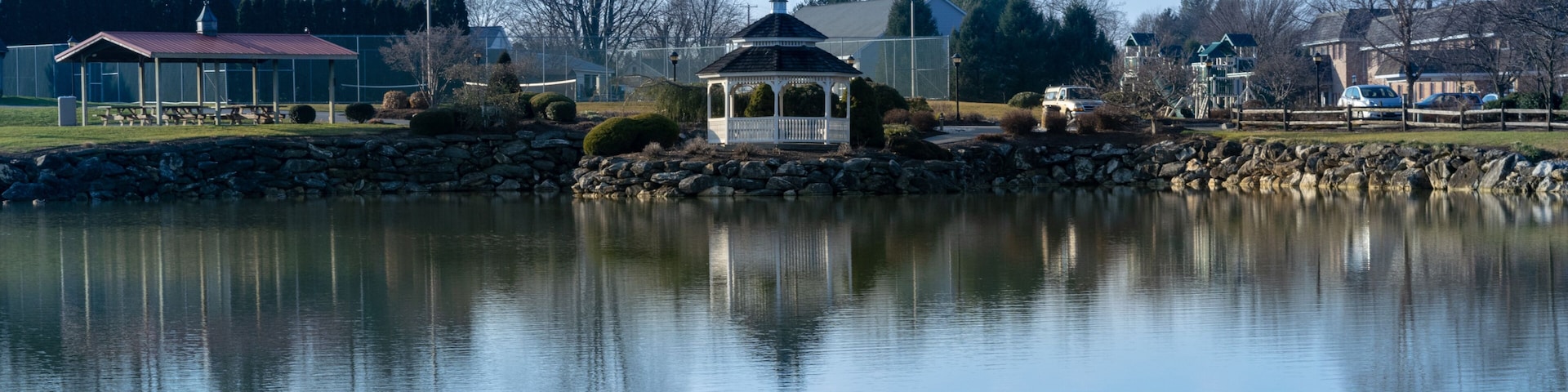 A small pond with a gazebo reflecting in the water, on a beautiful, calm and quiet day, Lancaster County, PA