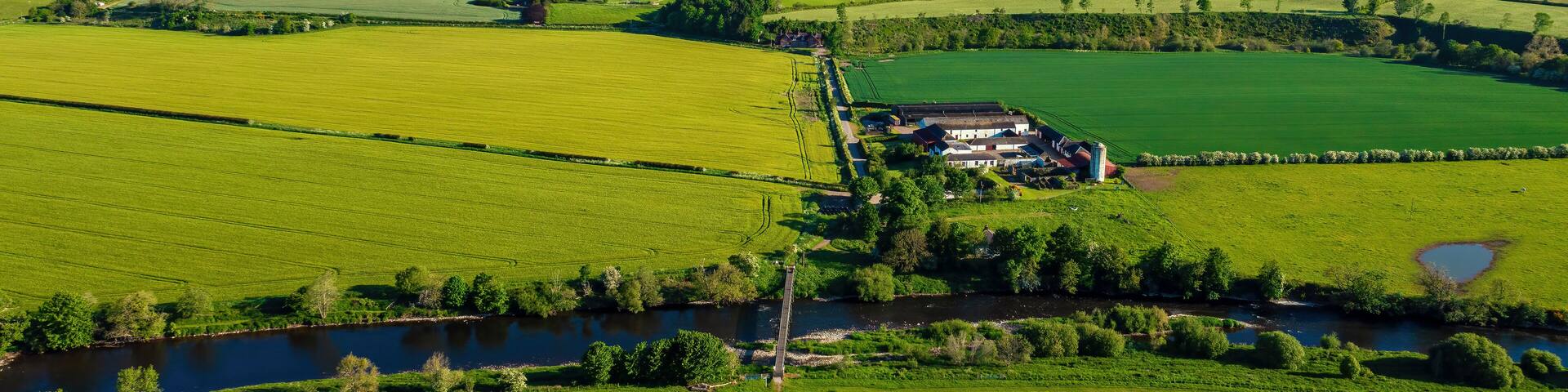Aerial view of green farmland along River Annan, Lockerbie, Scotland, United Kingdom.