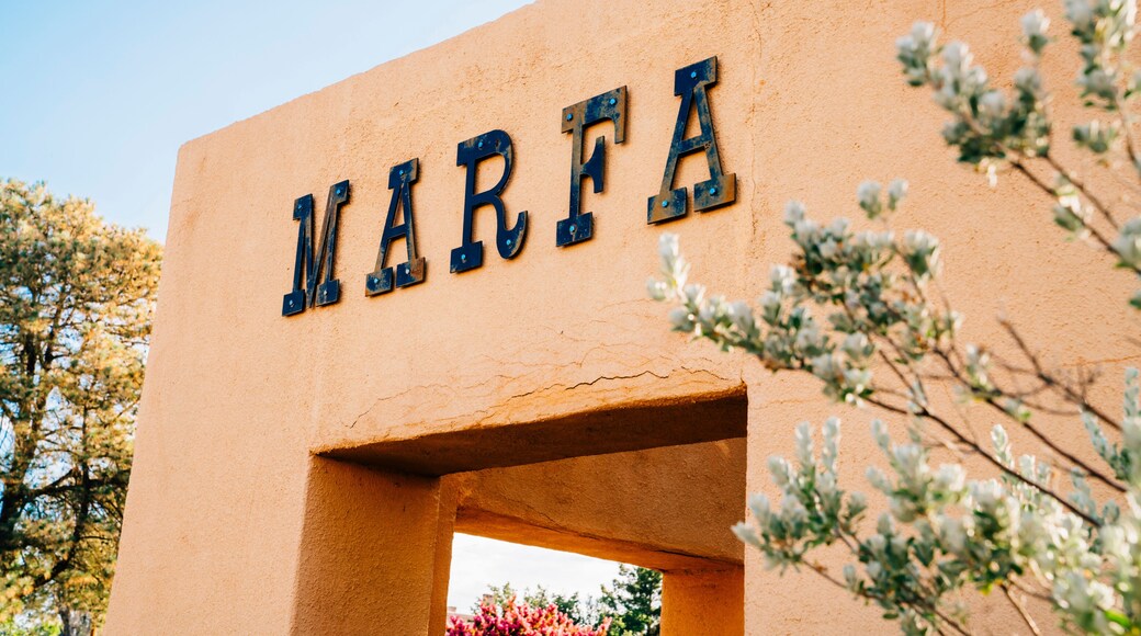 Sign for Marfa, Texas on side of stucco wall in park
