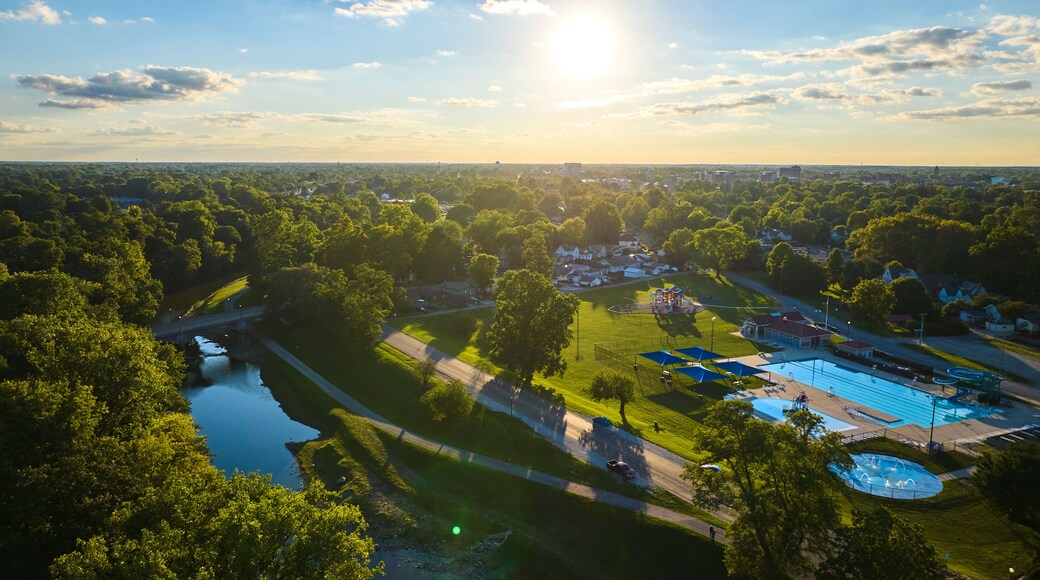 Tuhey Pool aerial in late afternoon with golden sunshine over neighborhood and White River, Muncie