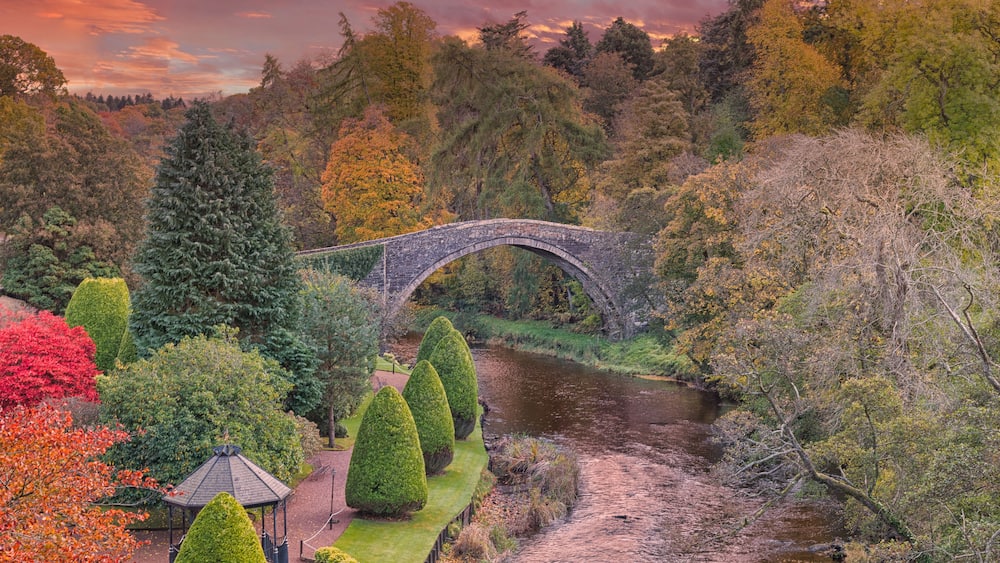BrigO-Doon and Ayrshire Gardens that Commemorate Burns in Autumn and the Old Brigg at sunset Alloway By Ayr Scotland.