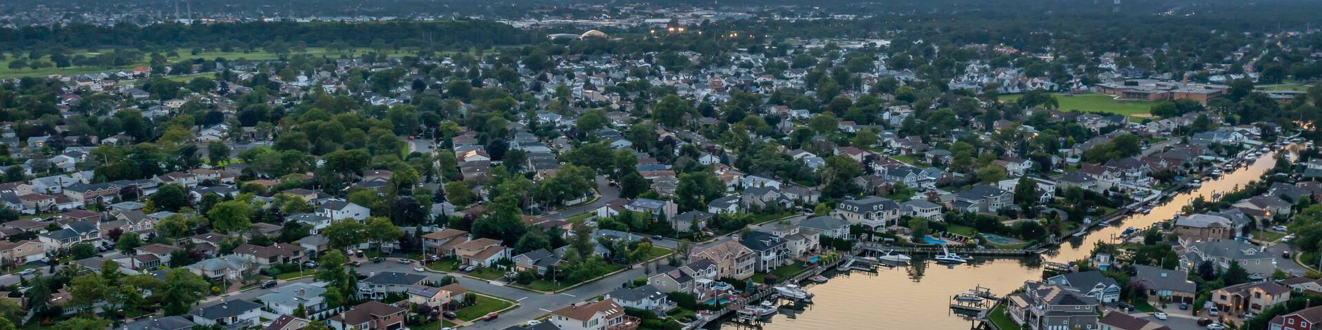 Merrick Long island at sunset aerial view bay homes canals boats orange