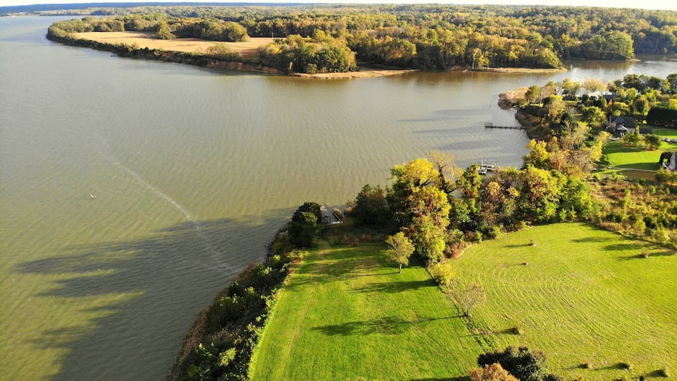 A river winding through a green landscape with trees and a golf course.