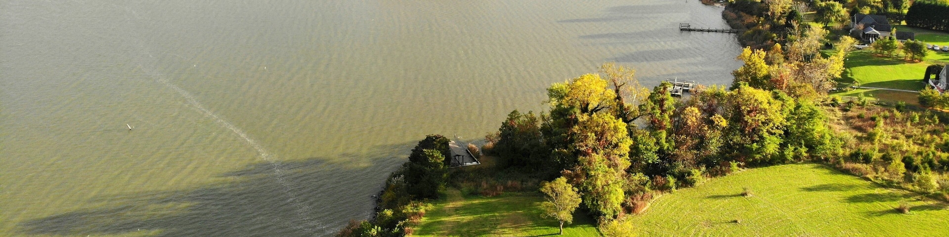 A river winding through a green landscape with trees and a golf course.