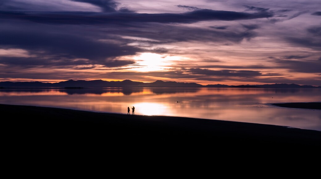 Great Salt Lake sunset with couple silhouettes and reflection