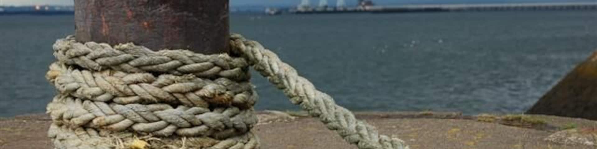 Charlestown harbour. A view westwards from the outer wall 475457 to the three cranes at the Royal Navy Armament Depot at Crombie.
