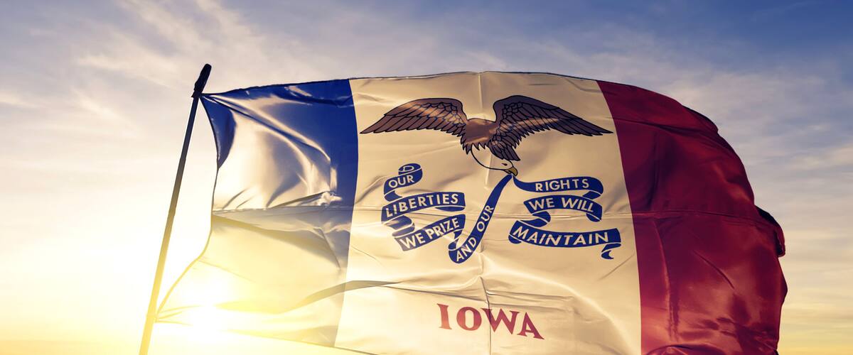 A flag with an eagle, the word 'Iowa,' and phrases like 'Our Liberties We Prize and Our Rights We Maintain.'