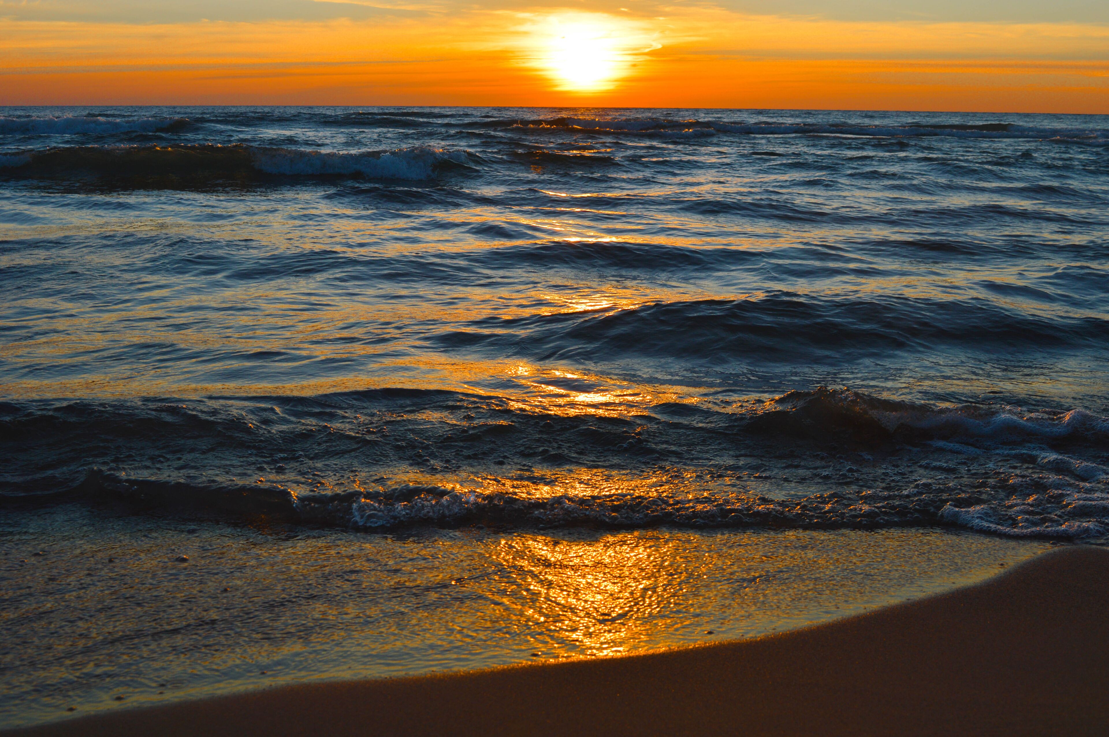 Brilliant sunrise over the waters of Lake Huron in Oscoda, Michigan