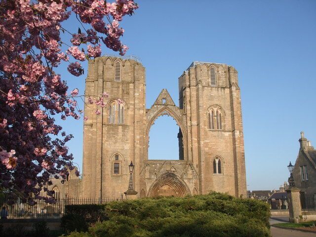 A historic stone cathedral with two prominent towers and a large central archway.