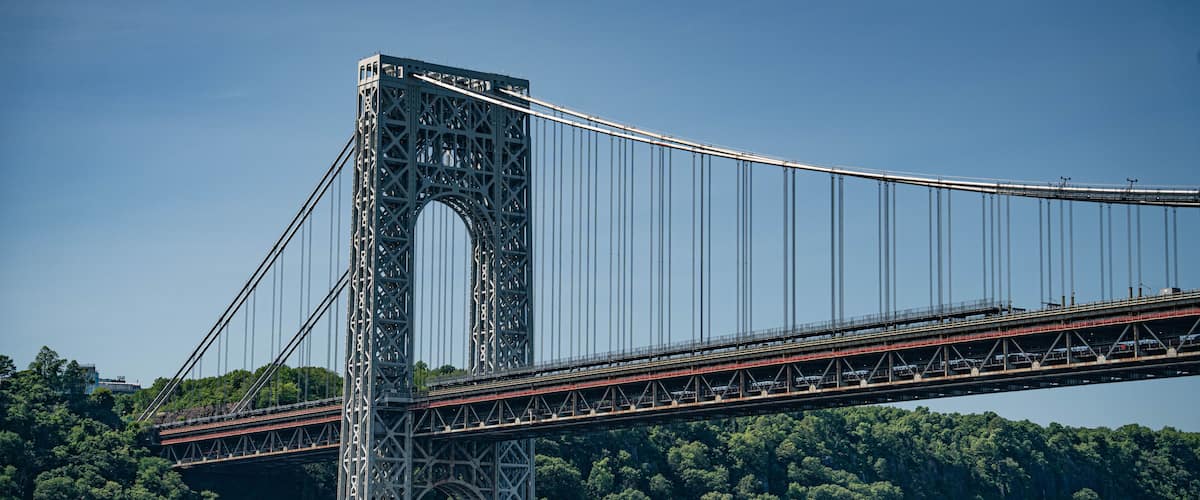 A large suspension bridge with a central tower and multiple cables.