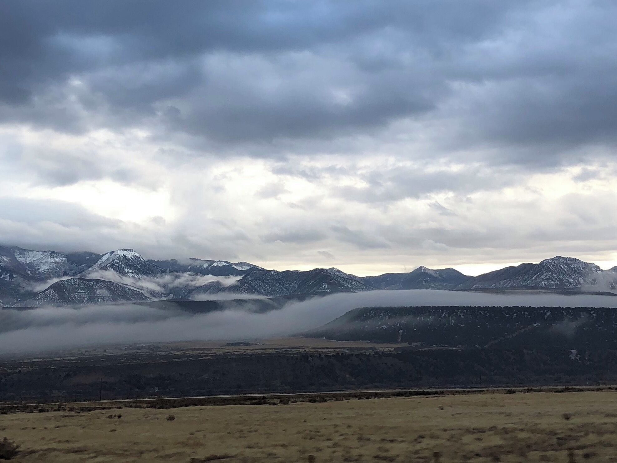 Low hanging clouds and the sun peeking through, this is awesome scenery just made better.