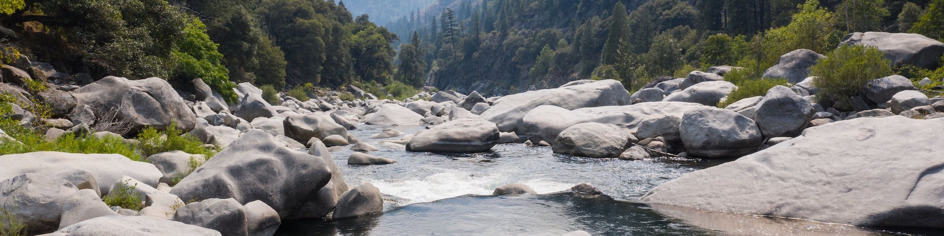 The beautiful Feather River flows through a scenic canyon in Northern California' Sierra Nevada Mountains. This beautiful flow of water is the principal tributary to the Sacramento River.