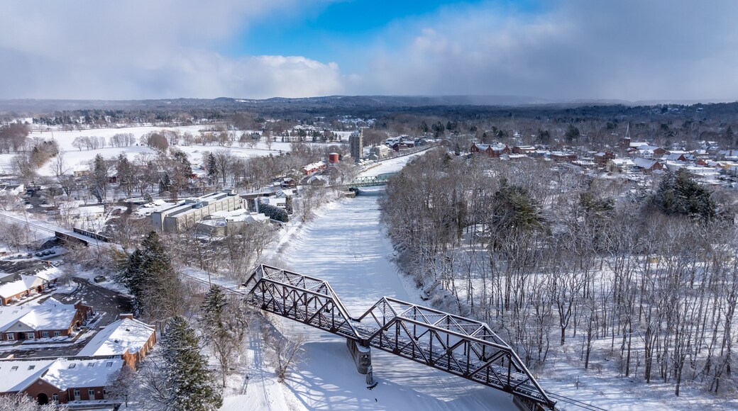 Pittsford, NY, USA - 02-01-2025: Winter afternoon aerial photo of the Village of Pittsford Schoen Place and the Erie Canal with snow on the ground.