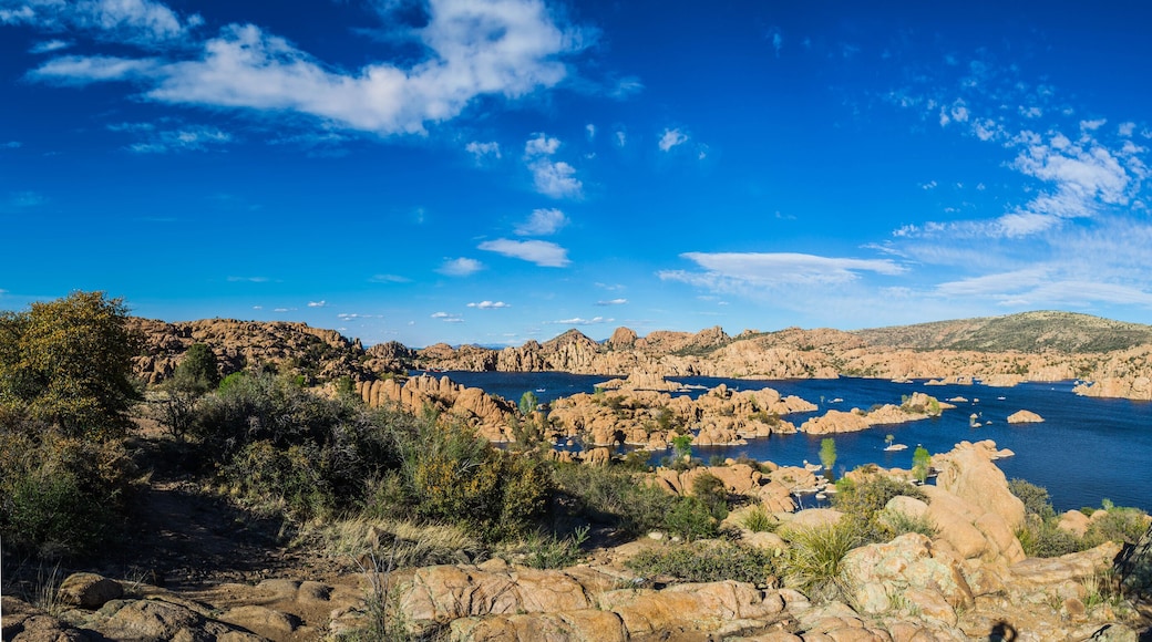 Panorama of the rugged beauty of Watson Lake in Prescott Arizona. This reservoir is surrounded be weathered cliffs of the Granite Dells and blear blue skies.