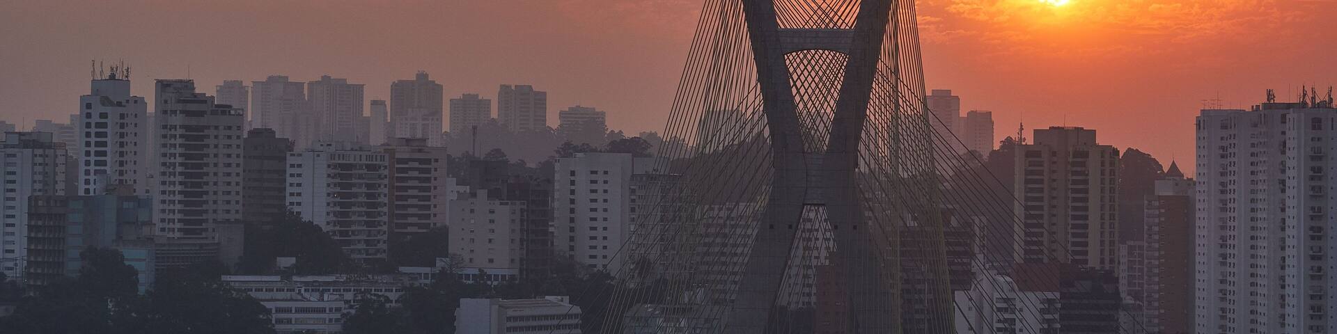 Octavio Frias de Oliveira bridge in Sao Paulo, Brazil against orange sunset sky