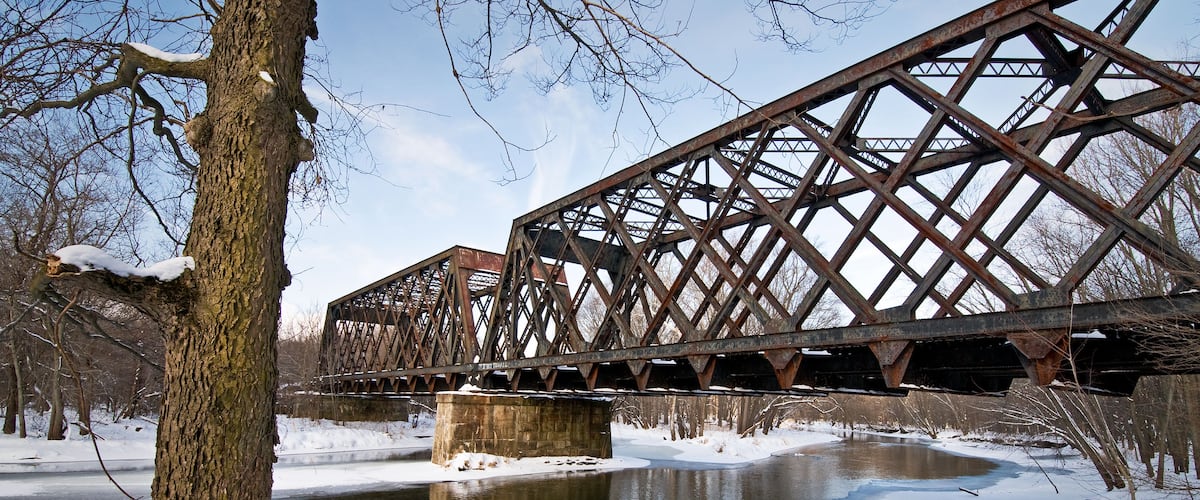Warm afternoon light from a winter sun brings out the rusty tones on the steel trusses of a former railroad bridge over the Tippecanoe River in northern Indiana.