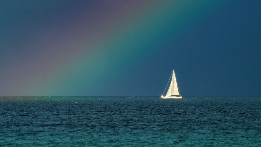 Snapped this photo with a 320mm lens on a crop sensor body. Storms brewing all around, and sail boat lined up perfectly with this beam of light causing a rainbow. #BVSblue photo contest