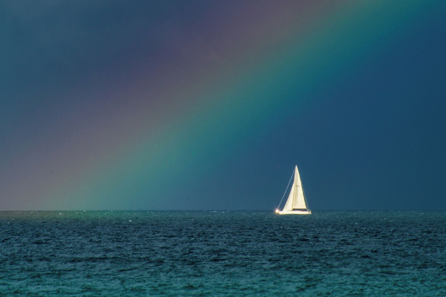 Snapped this photo with a 320mm lens on a crop sensor body. Storms brewing all around, and sail boat lined up perfectly with this beam of light causing a rainbow. #BVSblue photo contest