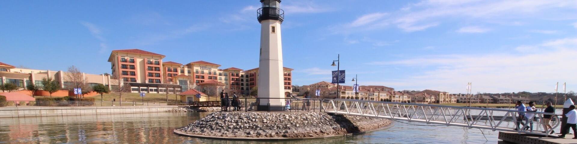 On the pier, facing hotel.