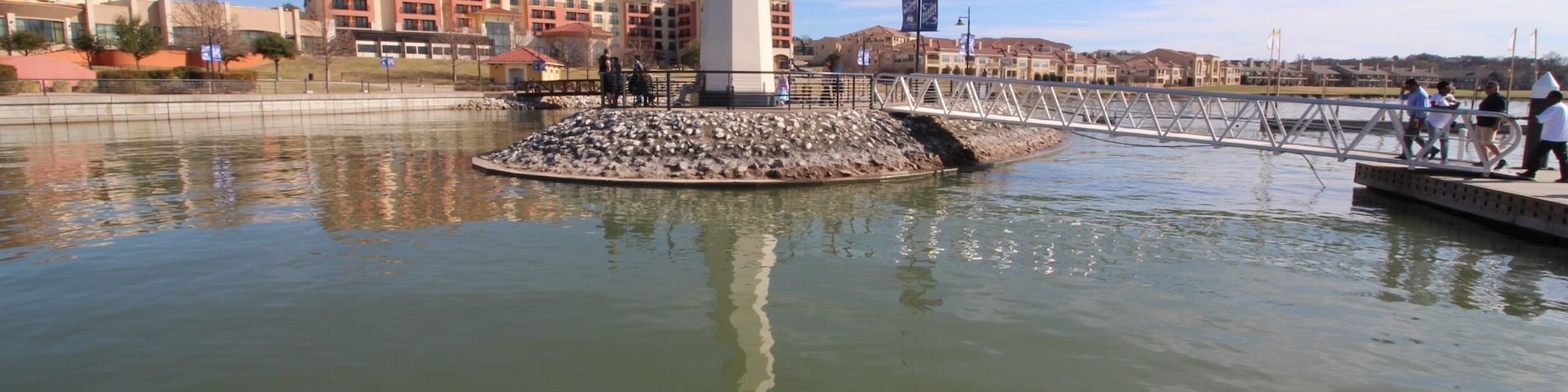 On the pier, facing hotel.