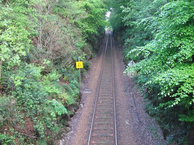 The West Highland Line at Torr. A view looking southeast from the bridge at Torr, along the West Highland railway line as it descends through a deep cutting towards Helensburgh.