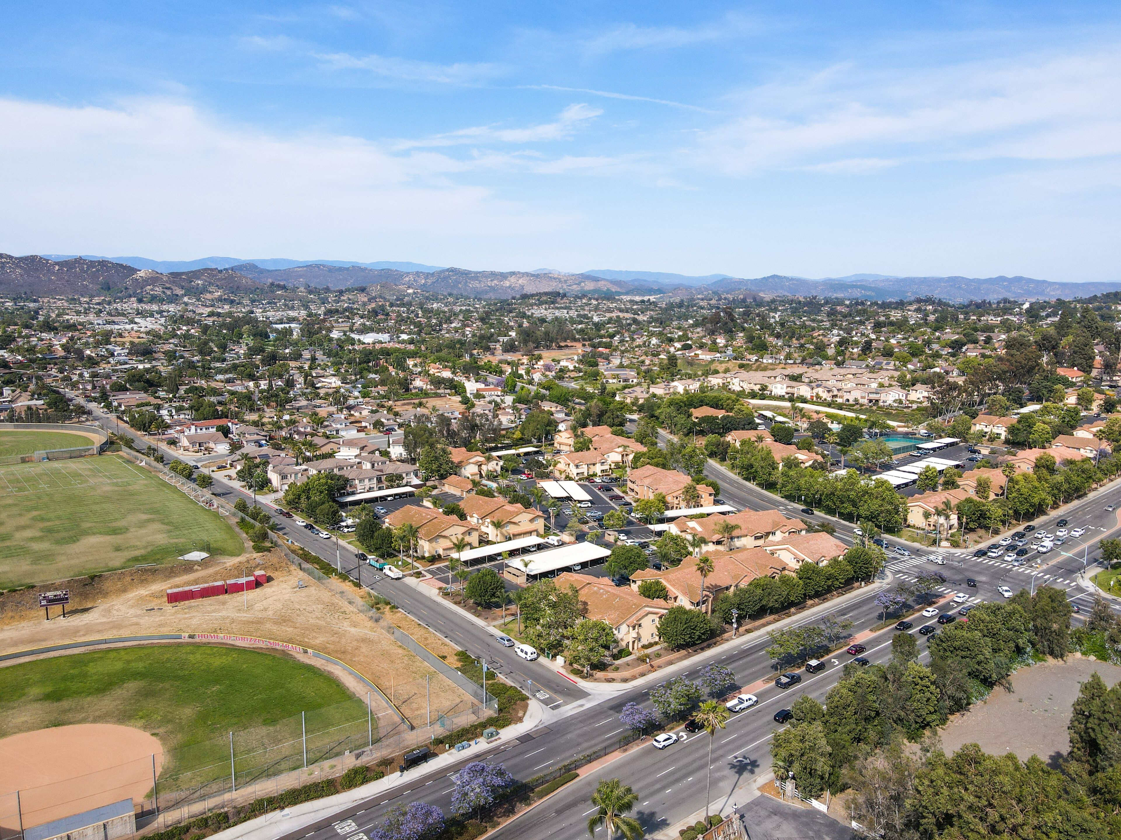 Aerial view of San Marcos neighborhood with houses and street during sunny day, California, USA.