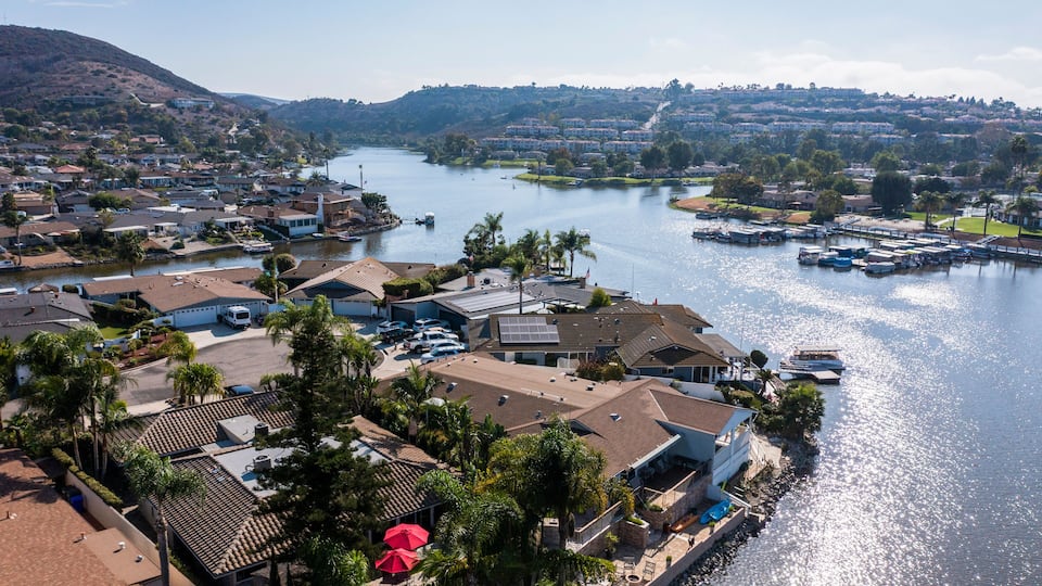 A residential area with houses, a marina, and a river.