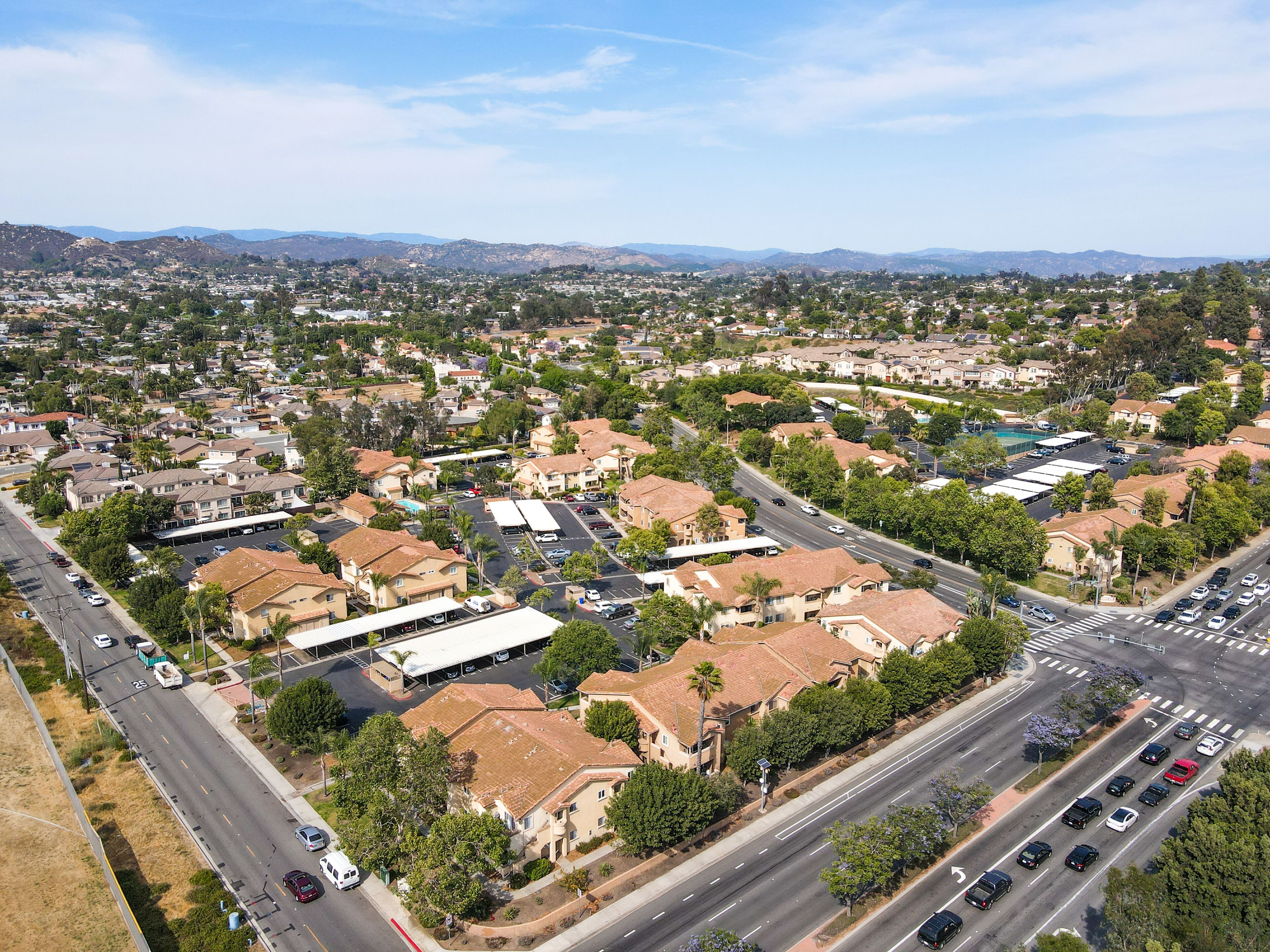 Aerial view of San Marcos neighborhood with houses and street during sunny day, California, USA.