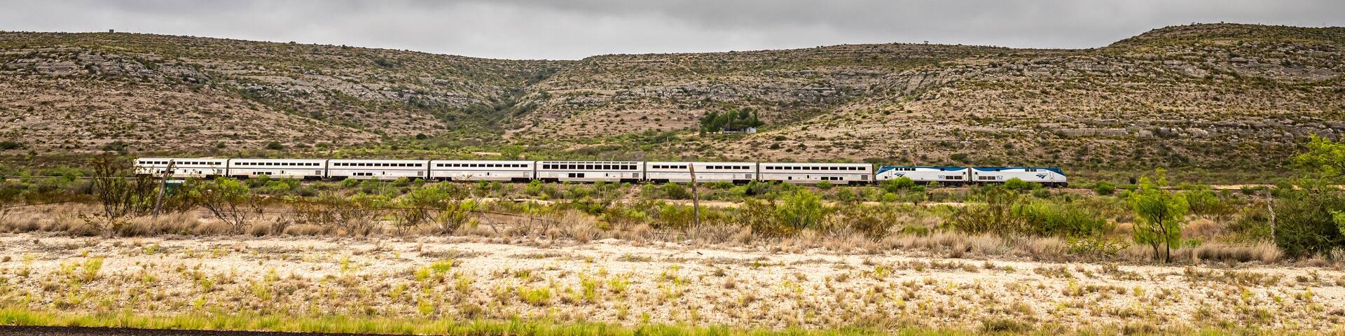 Terrell County, Texas / United States - June 2, 2020: The Amtrak Sunset Limited train travels through the desert near Sanderson, Texas.