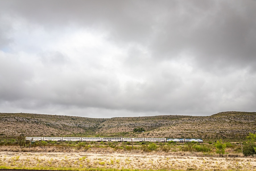 Terrell County, Texas / United States - June 2, 2020: The Amtrak Sunset Limited train travels through the desert near Sanderson, Texas.
