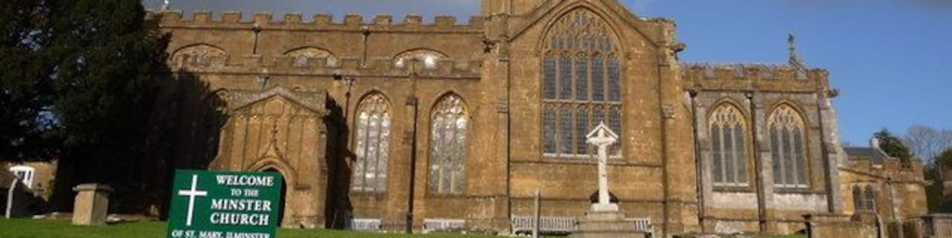 A historic church with a tall tower and arched windows.