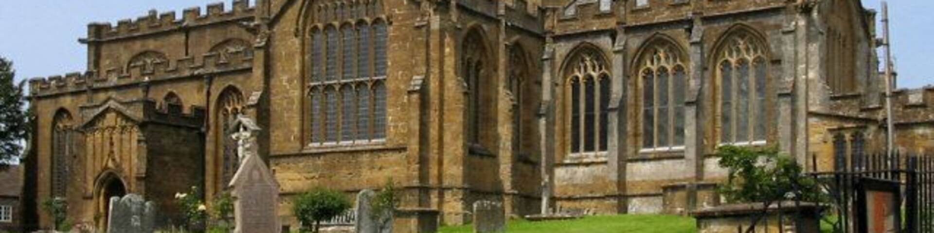 A historic church with a tall tower and arched windows.