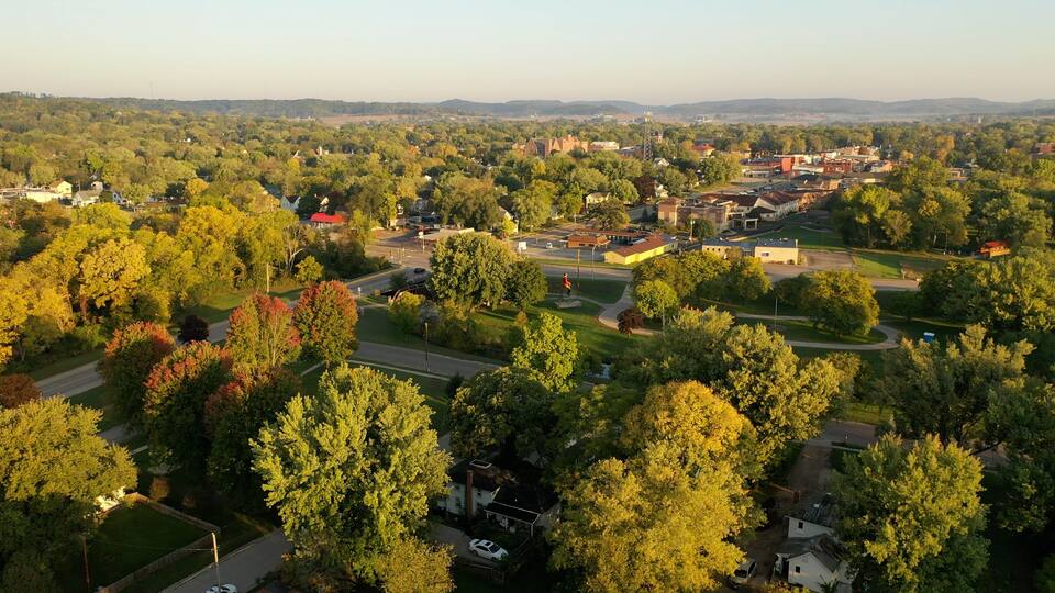 A town with a mix of residential houses, a church, and a golf course.