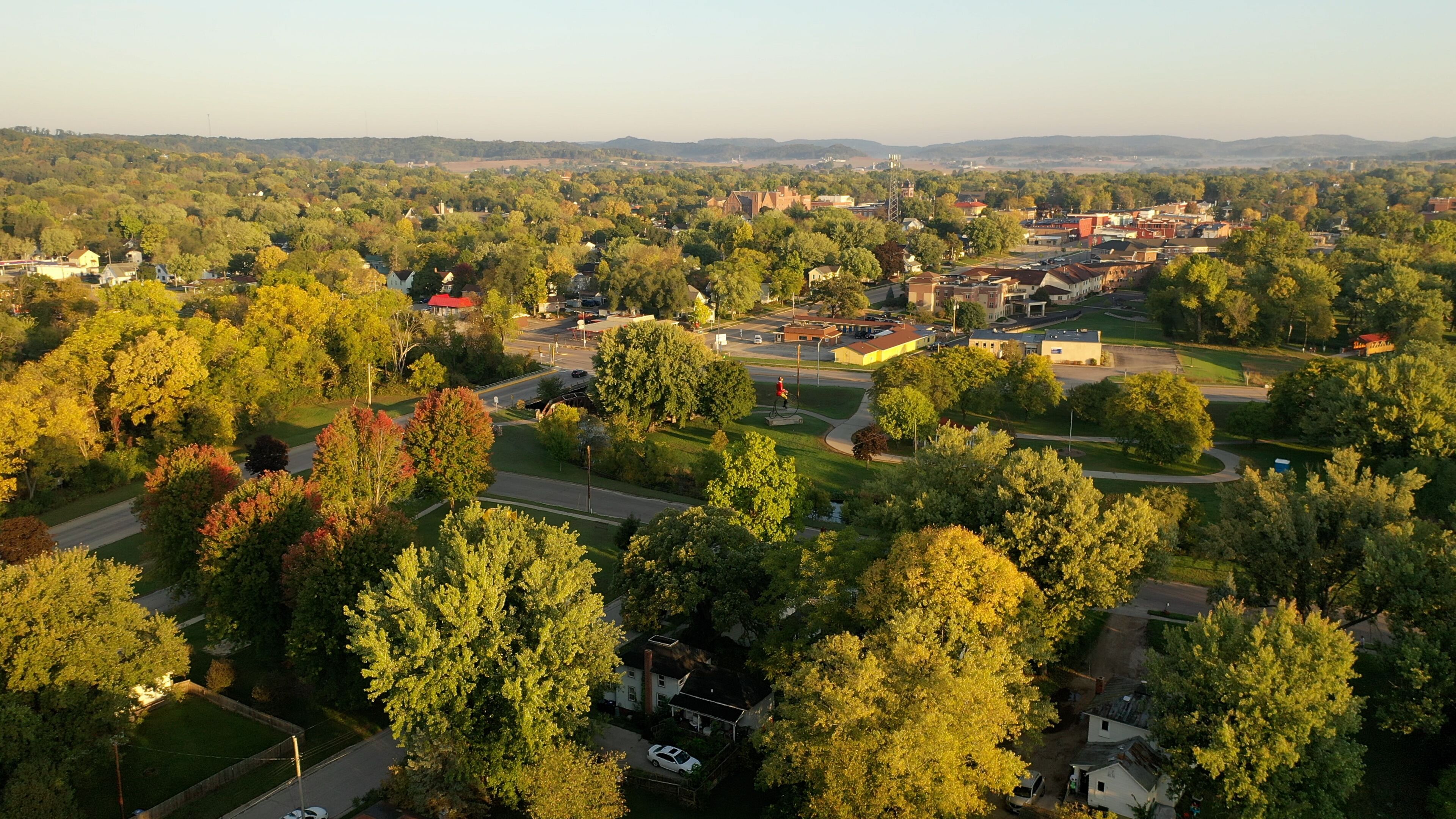 A town with a mix of residential houses, a church, and a golf course.