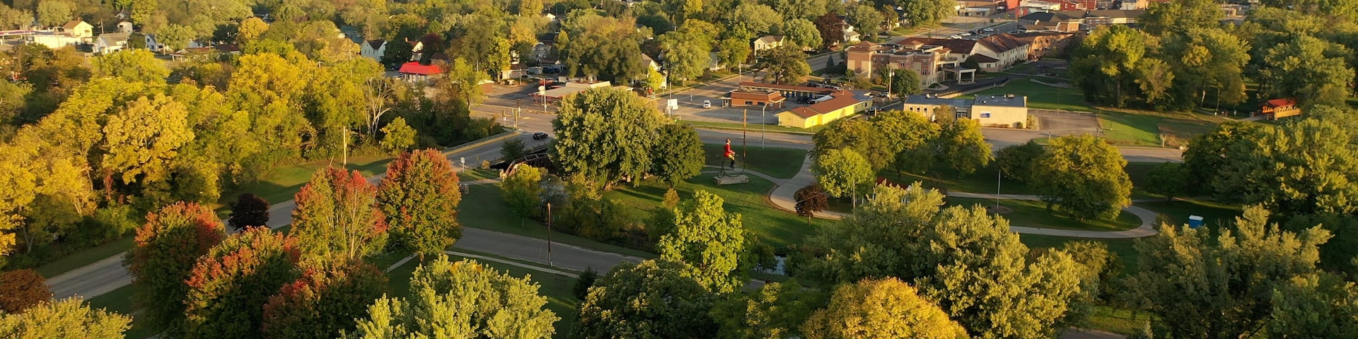 A town with a mix of residential houses, a church, and a golf course.